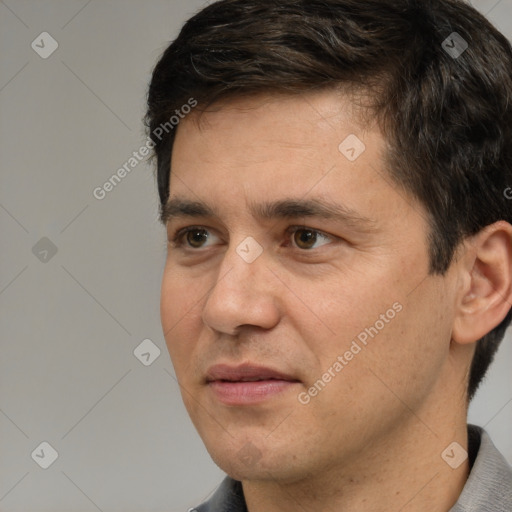 Joyful white adult male with short  black hair and brown eyes