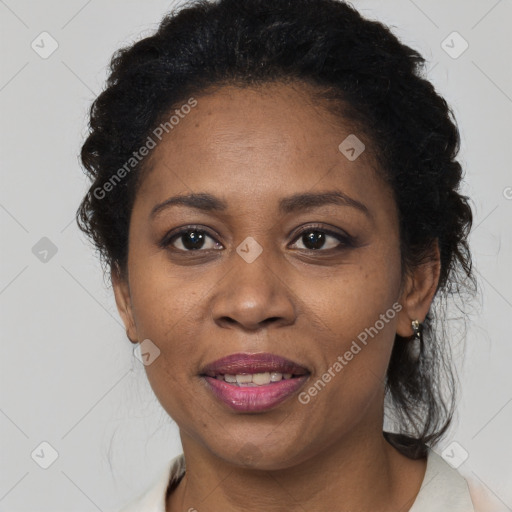 Joyful black adult female with short  brown hair and brown eyes