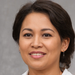 Joyful white adult female with medium  brown hair and brown eyes