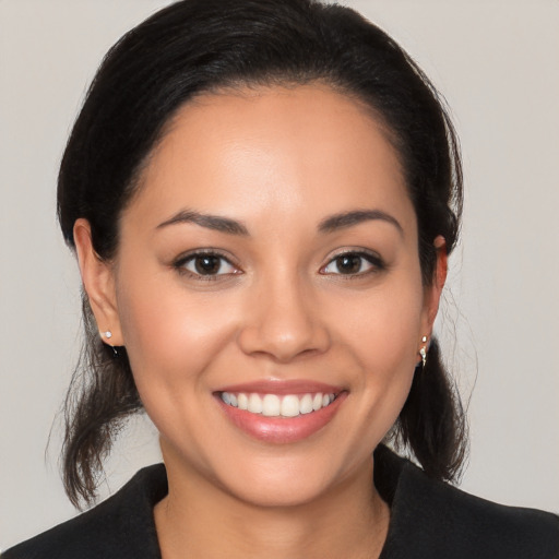 Joyful latino young-adult female with medium  black hair and brown eyes