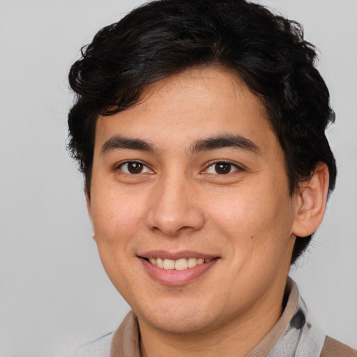 Joyful latino young-adult male with short  brown hair and brown eyes