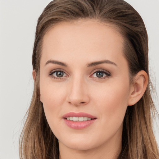 Joyful white young-adult female with long  brown hair and brown eyes