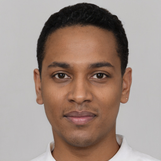 Joyful black young-adult male with short  black hair and brown eyes