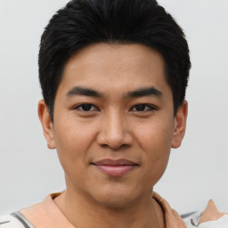 Joyful asian young-adult male with short  black hair and brown eyes