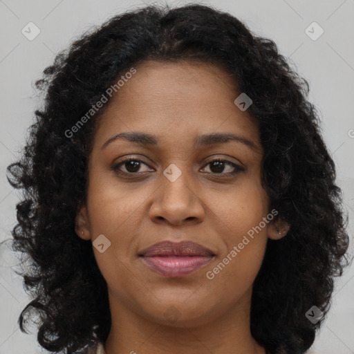 Joyful black young-adult female with long  brown hair and brown eyes