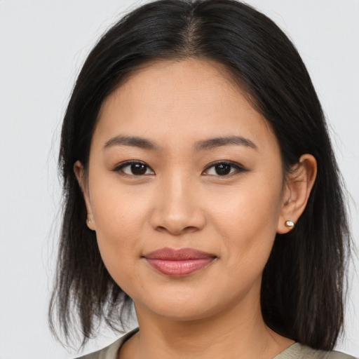 Joyful asian young-adult female with medium  brown hair and brown eyes