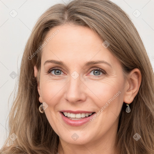 Joyful white adult female with long  brown hair and grey eyes