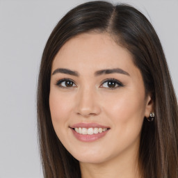 Joyful white young-adult female with long  brown hair and brown eyes