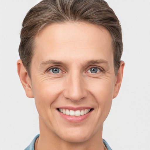 Joyful white adult female with short  brown hair and grey eyes