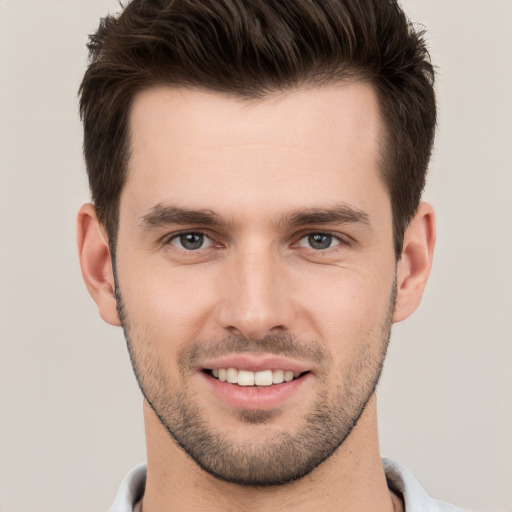 Joyful white young-adult male with short  brown hair and brown eyes