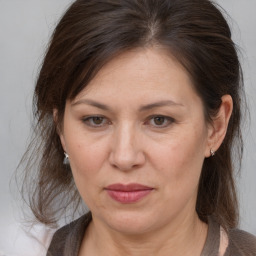 Joyful white adult female with medium  brown hair and grey eyes