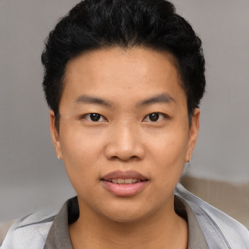 Joyful asian young-adult male with short  black hair and brown eyes