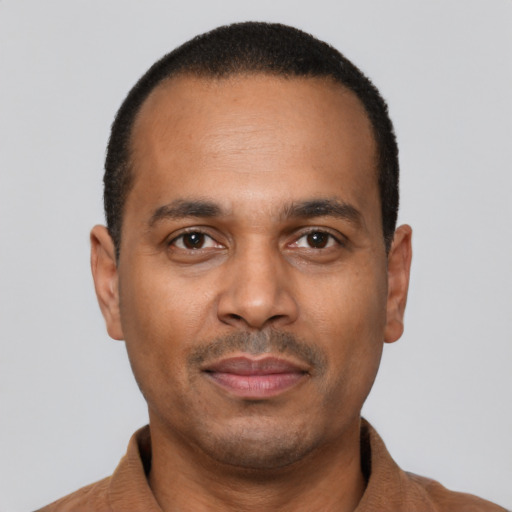 Joyful latino adult male with short  black hair and brown eyes