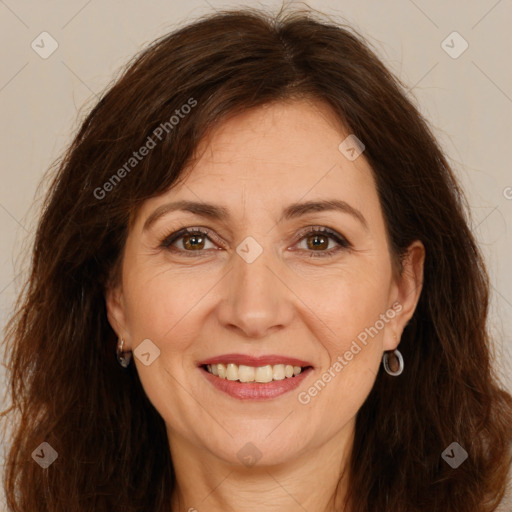 Joyful white adult female with long  brown hair and brown eyes