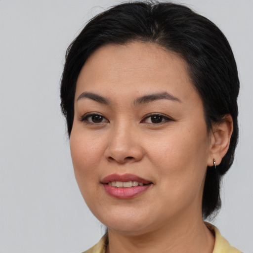 Joyful asian young-adult female with medium  brown hair and brown eyes