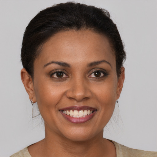 Joyful black young-adult female with medium  brown hair and brown eyes