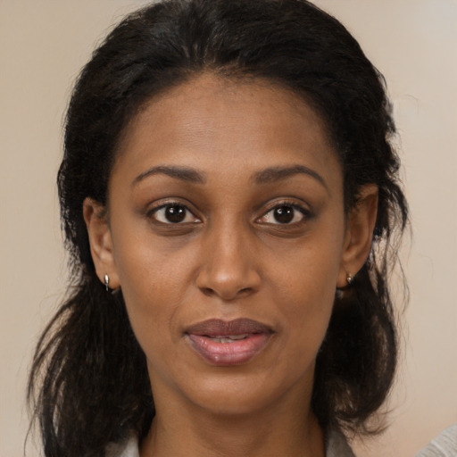 Joyful black young-adult female with medium  brown hair and brown eyes