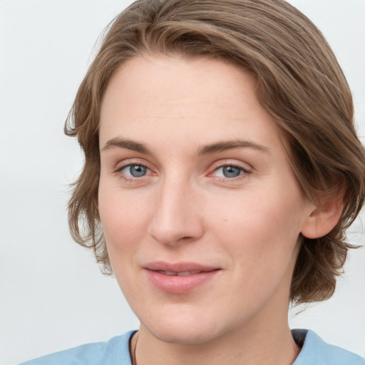 Joyful white young-adult female with medium  brown hair and blue eyes