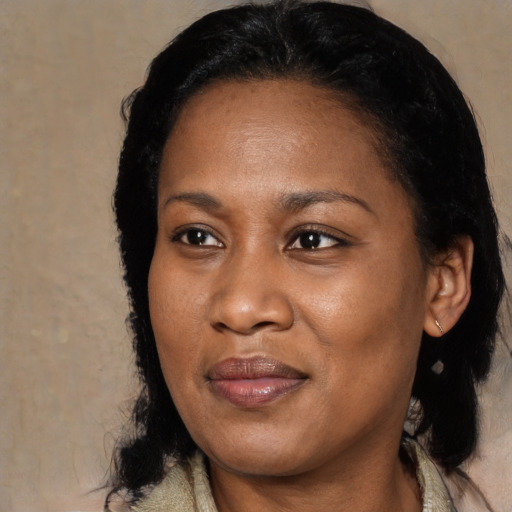 Joyful black adult female with medium  black hair and brown eyes