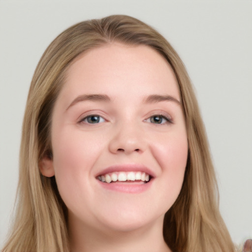 Joyful white young-adult female with long  brown hair and blue eyes