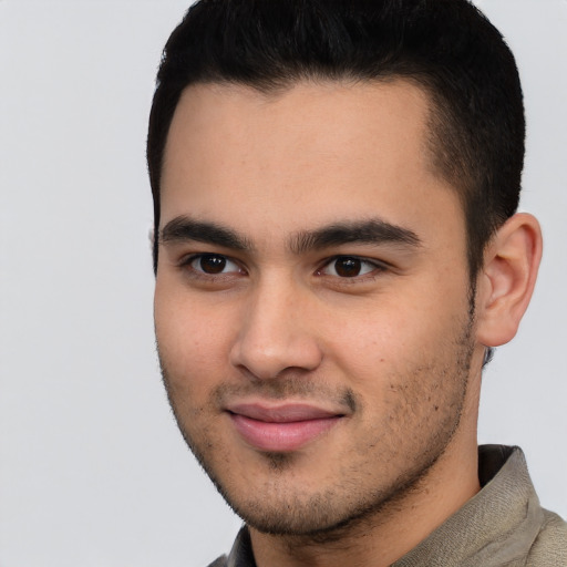 Joyful latino young-adult male with short  brown hair and brown eyes