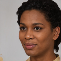 Joyful black young-adult female with short  black hair and brown eyes