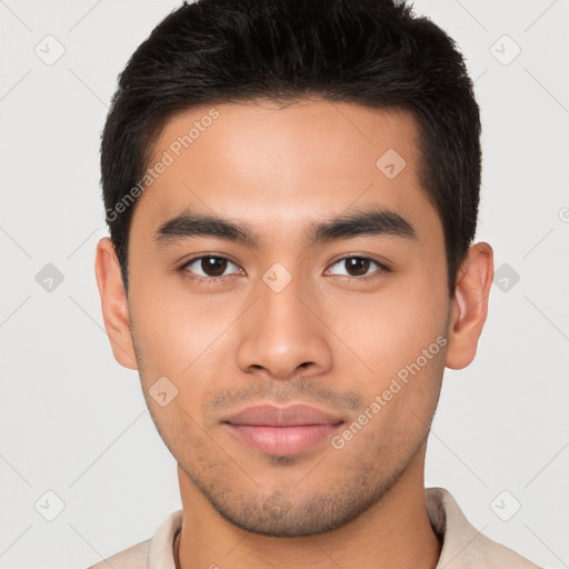 Joyful latino young-adult male with short  brown hair and brown eyes