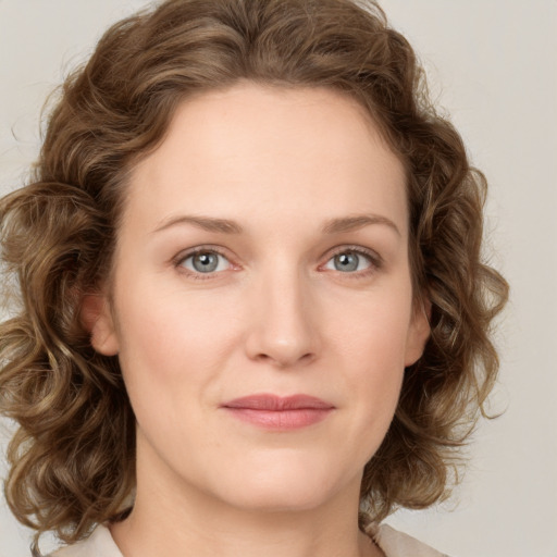 Joyful white young-adult female with medium  brown hair and green eyes