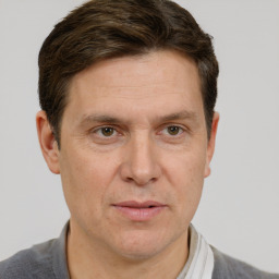 Joyful white adult male with short  brown hair and grey eyes