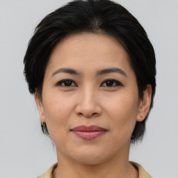 Joyful asian adult female with medium  brown hair and brown eyes