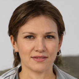 Joyful white adult female with medium  brown hair and brown eyes