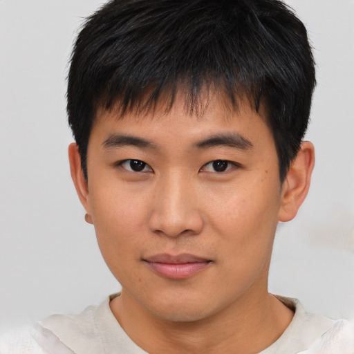 Joyful asian young-adult male with short  brown hair and brown eyes