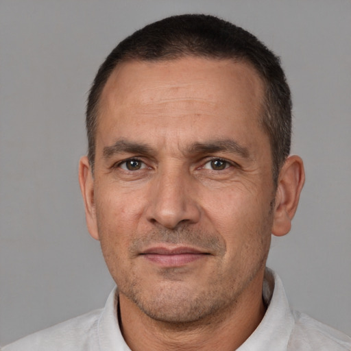 Joyful white adult male with short  brown hair and brown eyes