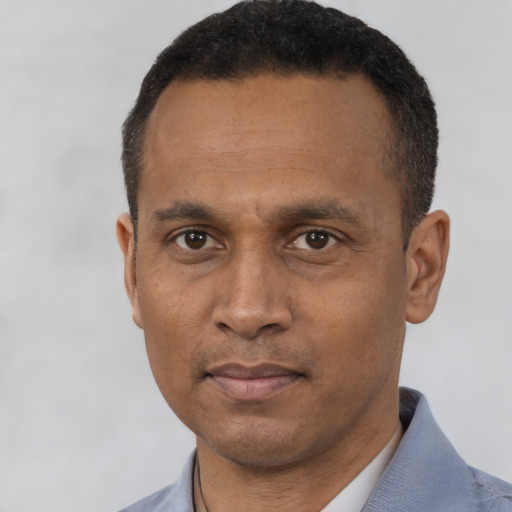 Neutral black adult male with short  black hair and brown eyes
