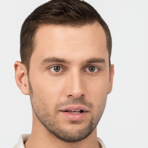 Joyful white young-adult male with short  brown hair and brown eyes