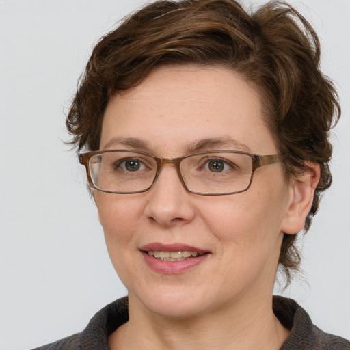 Joyful white adult female with medium  brown hair and blue eyes