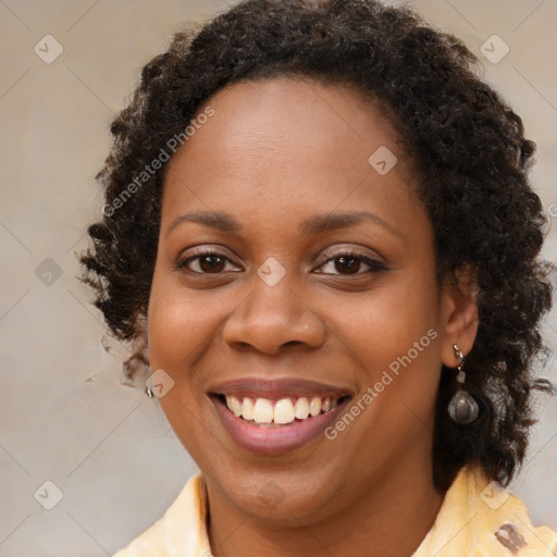 Joyful black young-adult female with medium  brown hair and brown eyes