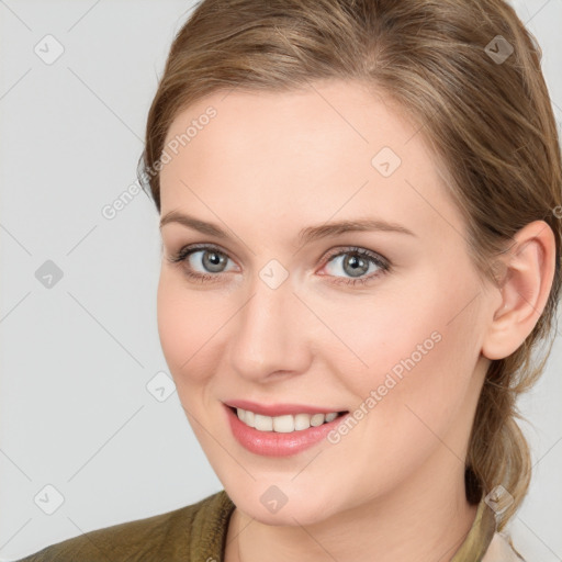 Joyful white young-adult female with medium  brown hair and grey eyes