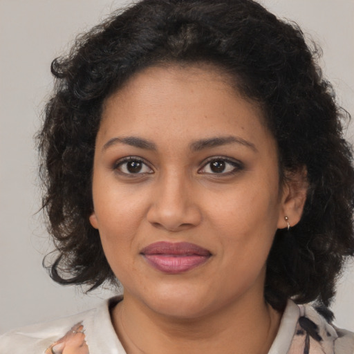 Joyful black young-adult female with medium  brown hair and brown eyes