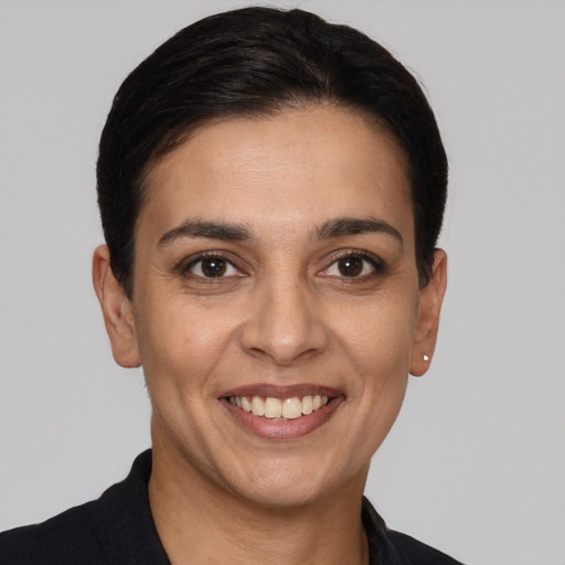 Joyful white young-adult female with short  black hair and brown eyes