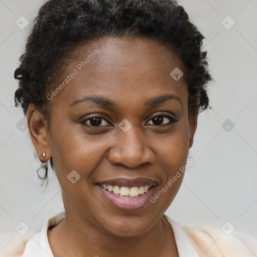 Joyful black young-adult female with short  brown hair and brown eyes