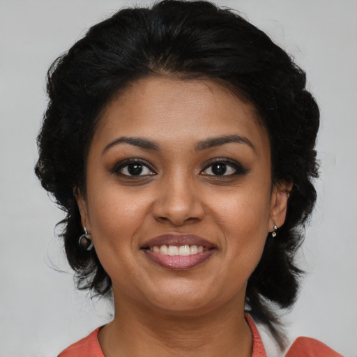 Joyful black young-adult female with medium  black hair and brown eyes