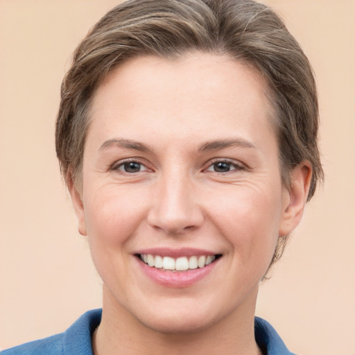 Joyful white young-adult female with short  brown hair and grey eyes