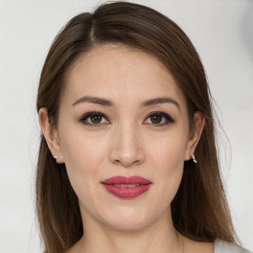 Joyful white young-adult female with long  brown hair and brown eyes