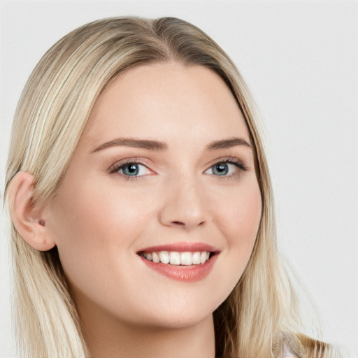 Joyful white young-adult female with long  brown hair and blue eyes