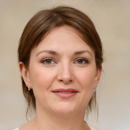 Joyful white young-adult female with medium  brown hair and grey eyes