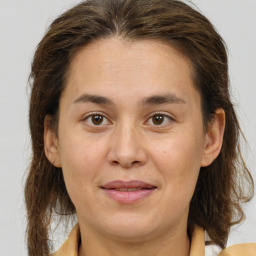 Joyful white adult female with medium  brown hair and brown eyes