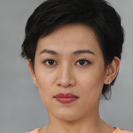 Joyful asian young-adult female with short  black hair and brown eyes