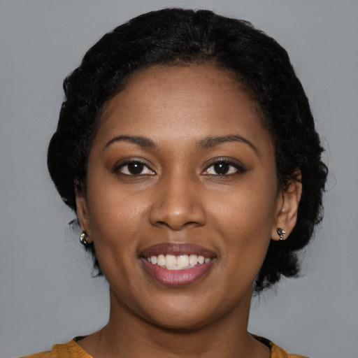 Joyful black young-adult female with medium  black hair and brown eyes