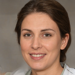 Joyful white adult female with medium  brown hair and green eyes